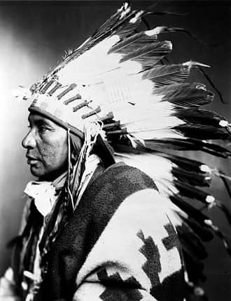 Shoshone Indian wearing war bonnet